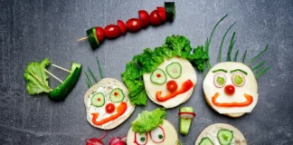 Gesichter aus Gemüse auf Broten und Gemüsespießen als Symbolbild für vegetarische und vegane Ernährung bei Kindern.